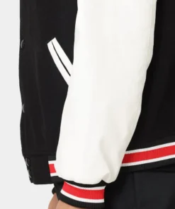 stussy world tour varsity jacket navy and white varsity jacket sleeve closeup view