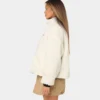 women wear a stussy reversible box fit sherpa jacket left side