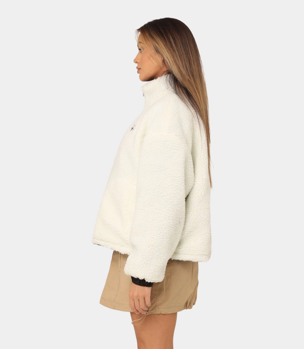 women wear a stussy reversible box fit sherpa jacket left side