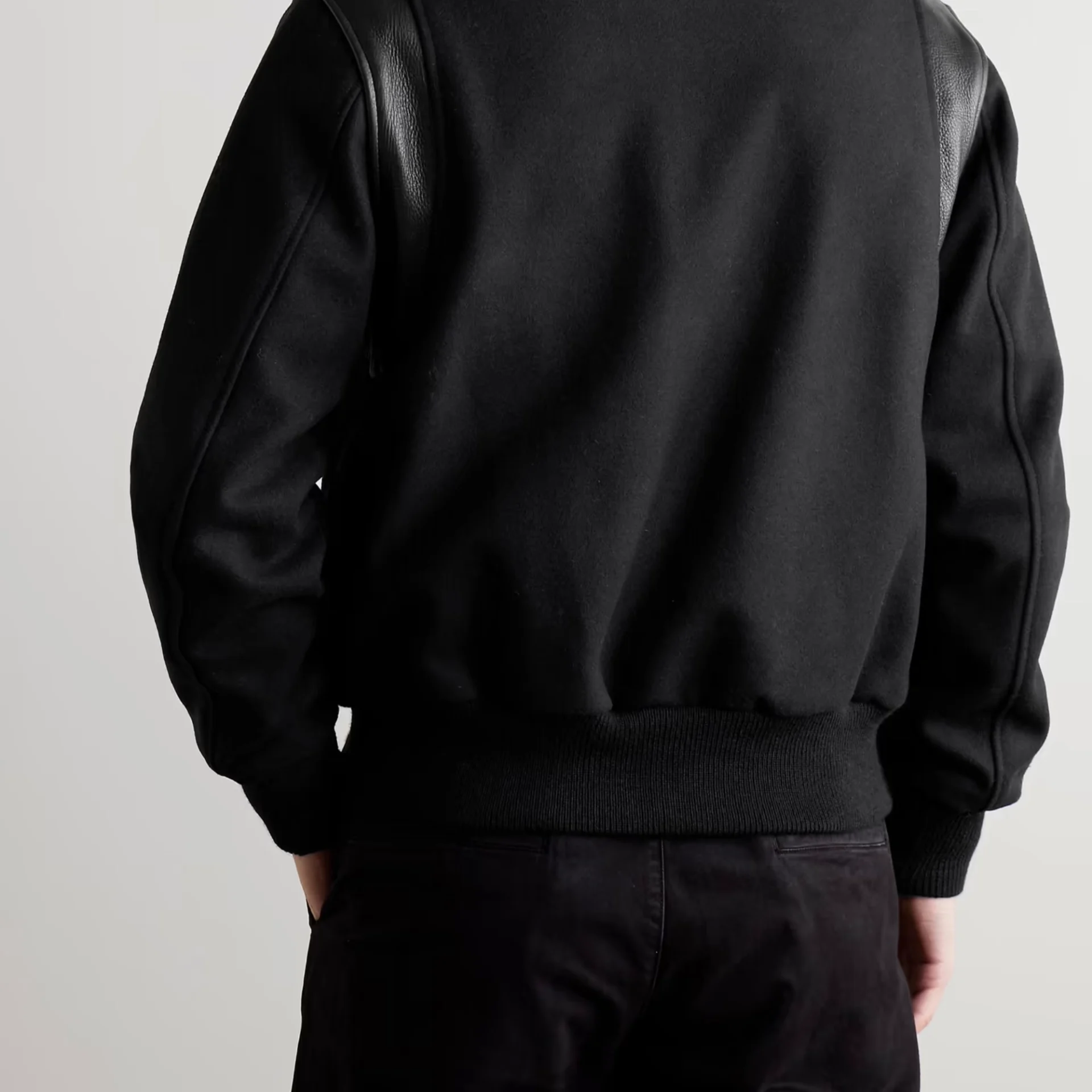 stussy leather trimmed wool varsity bomber jacket man back view
